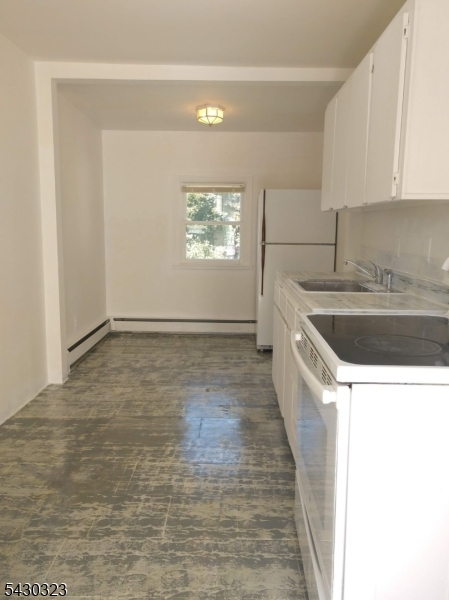 83 Allen Street, Unit 1 Netcong, NJ 07857 - Photo 5 of 16 a view of kitchen with stainless steel appliances granite countertop a sink and a white stove