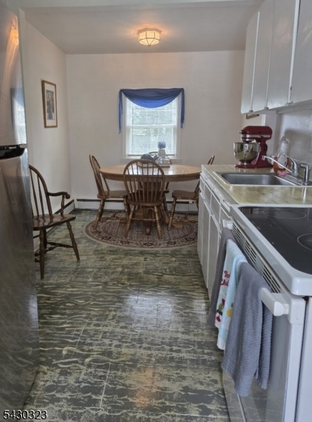 83 Allen Street, Unit 1 Netcong, NJ 07857 - Photo 6 of 16 a dining room with furniture a rug and a chandelier