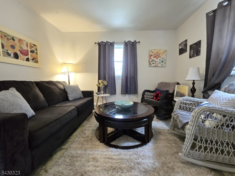 83 Allen Street, Unit 1 Netcong, NJ 07857 - Photo 9 of 16 a living room with furniture and a mirror