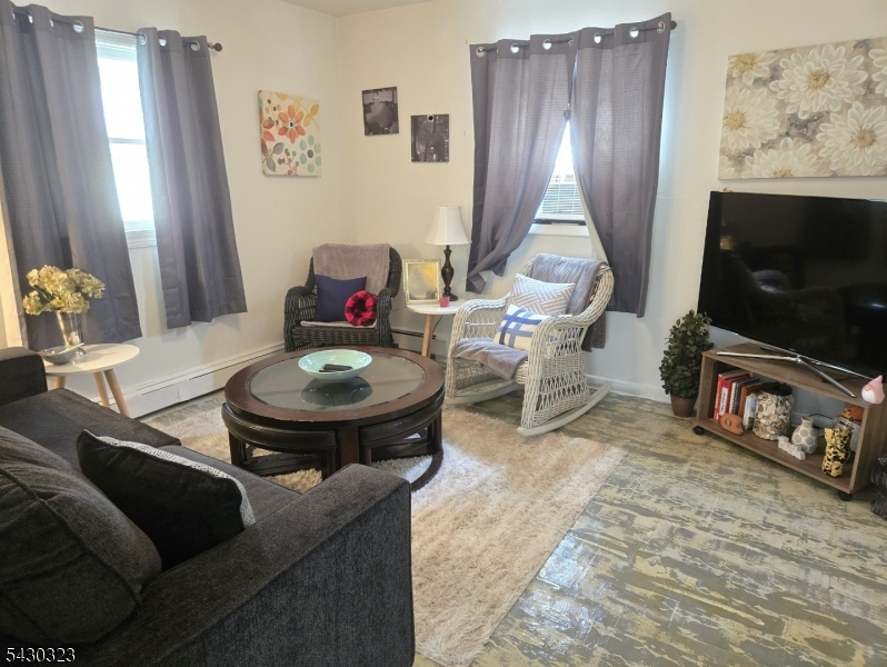 83 Allen Street, Unit 1 Netcong, NJ 07857 - Photo 10 of 16 a living room with furniture a flat screen tv and a window