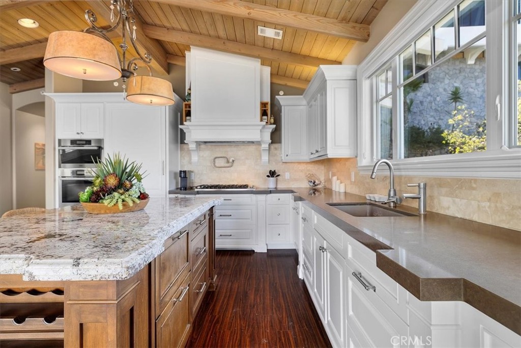 133 Upper Terrace Road Avalon, CA 90704 - Photo 11 of 72 a kitchen with stainless steel appliances granite countertop a sink a stove and a wooden floors