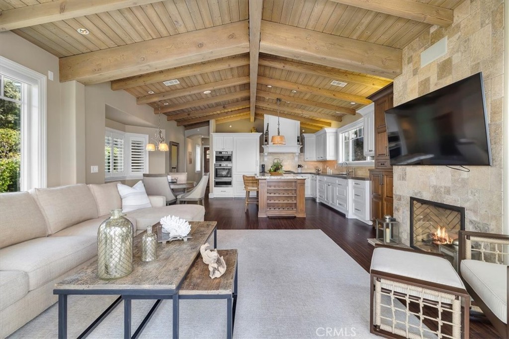 133 Upper Terrace Road Avalon, CA 90704 - Photo 18 of 72 a living room with furniture a flat screen tv and a fireplace