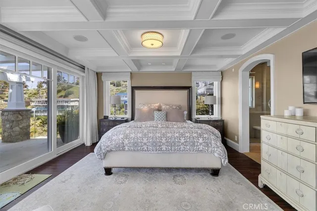a living room with furniture a rug and a floor to ceiling window