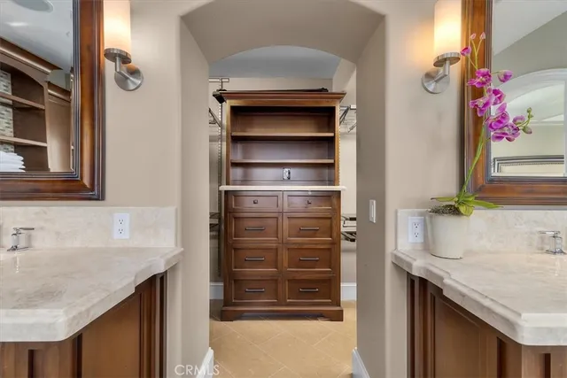 a bathroom with a granite countertop sink a mirror and a shower