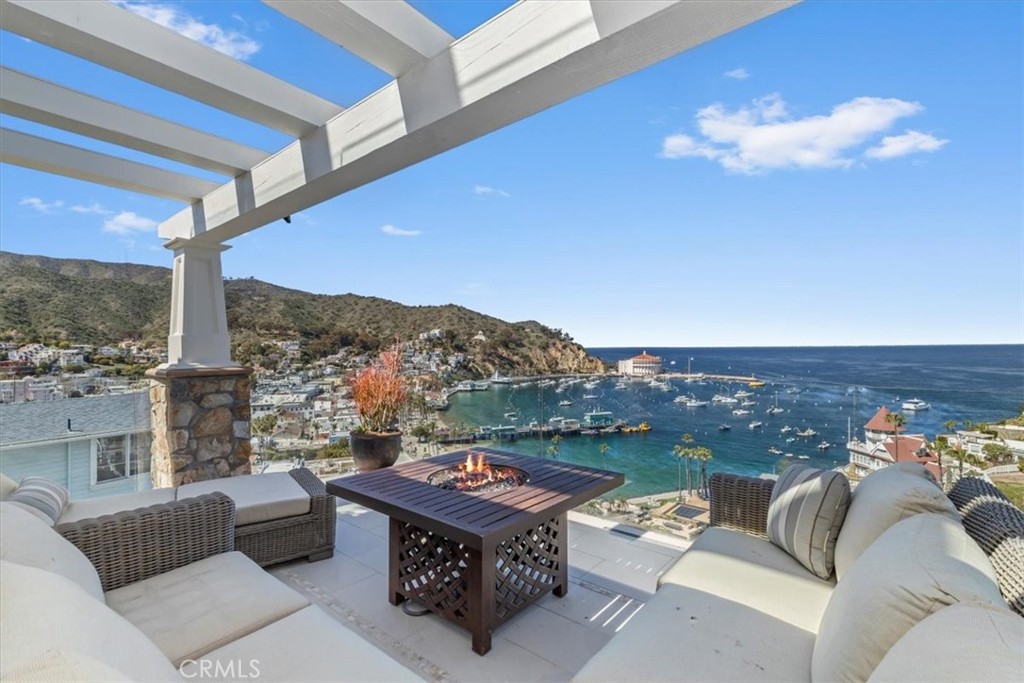 133 Upper Terrace Road Avalon, CA 90704 - Photo 28 of 72 a living room with furniture a rug and a floor to ceiling window