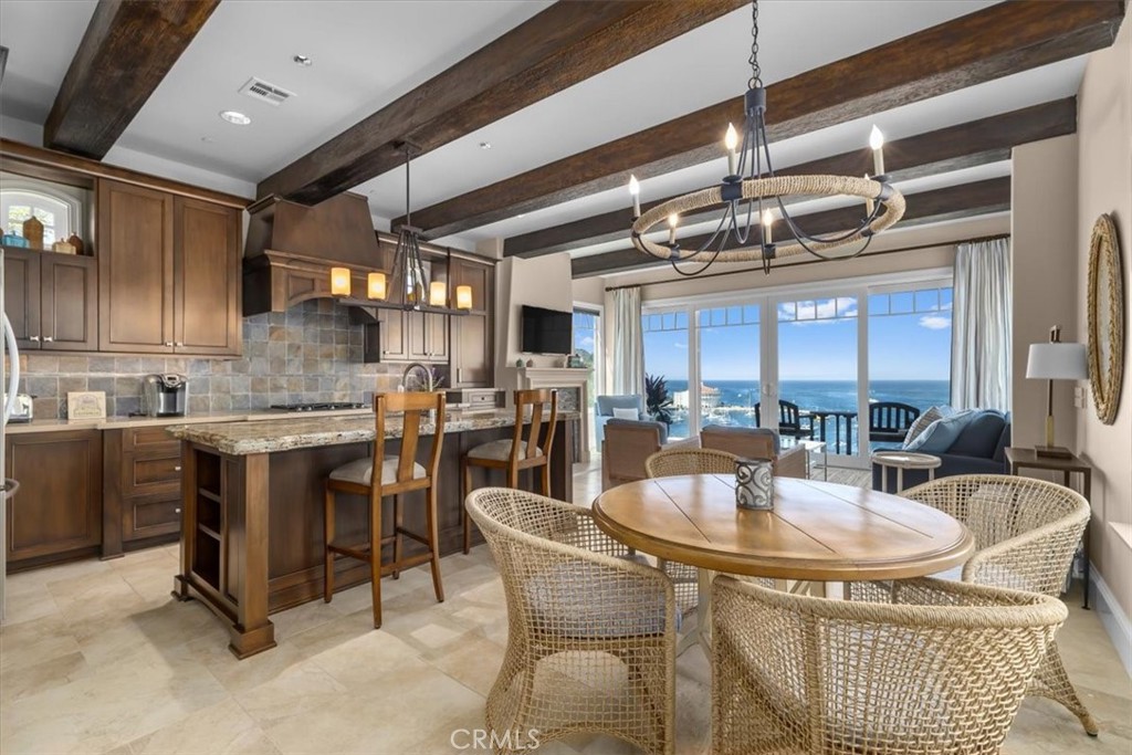 133 Upper Terrace Road Avalon, CA 90704 - Photo 38 of 72 a kitchen with a dining table chairs sink and granite counter top