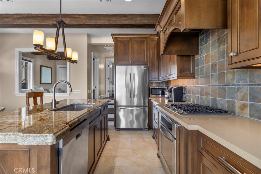 133 Upper Terrace Road Avalon, CA 90704 - Photo 40 of 72 a kitchen with stainless steel appliances granite countertop a sink stove and cabinets