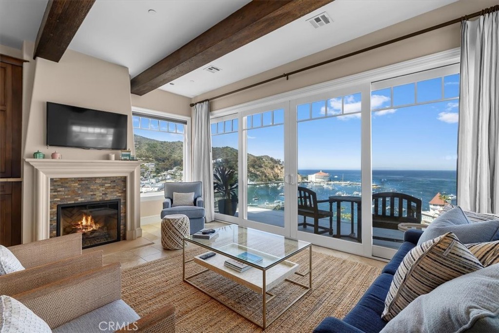 133 Upper Terrace Road Avalon, CA 90704 - Photo 42 of 72 a living room with furniture a flat screen tv and a fireplace