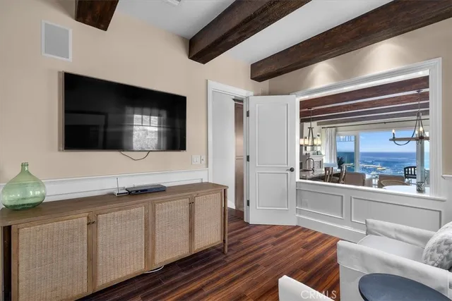 a room with gym equipment and wooden floor