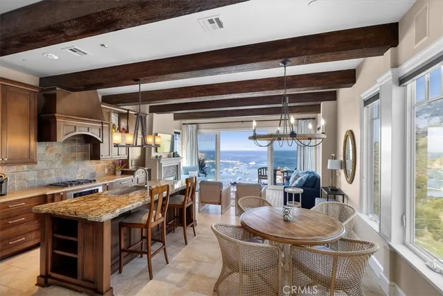 a kitchen with kitchen island a counter top space and stainless steel appliances