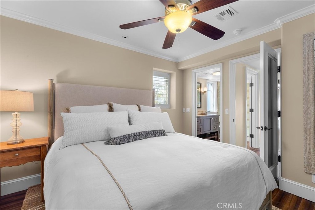 133 Upper Terrace Road Avalon, CA 90704 - Photo 49 of 72 a bedroom with a bed and a chandelier