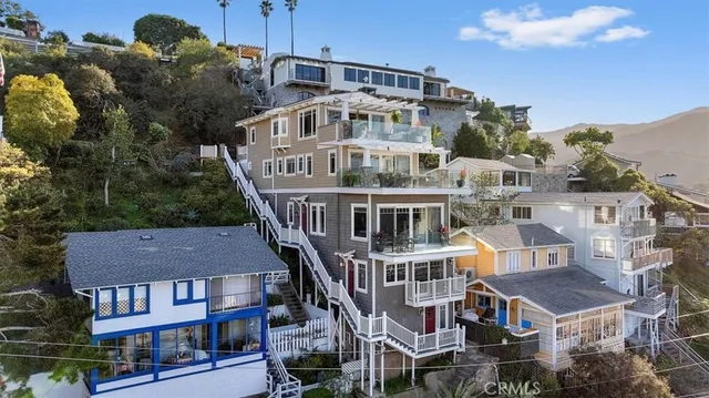 a dining room with stainless steel appliances granite countertop a table chairs and wooden floor