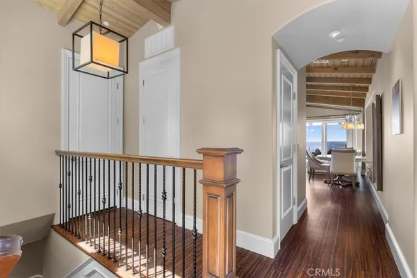 a kitchen with stainless steel appliances granite countertop a stove a refrigerator a dining table and chairs with wooden floor
