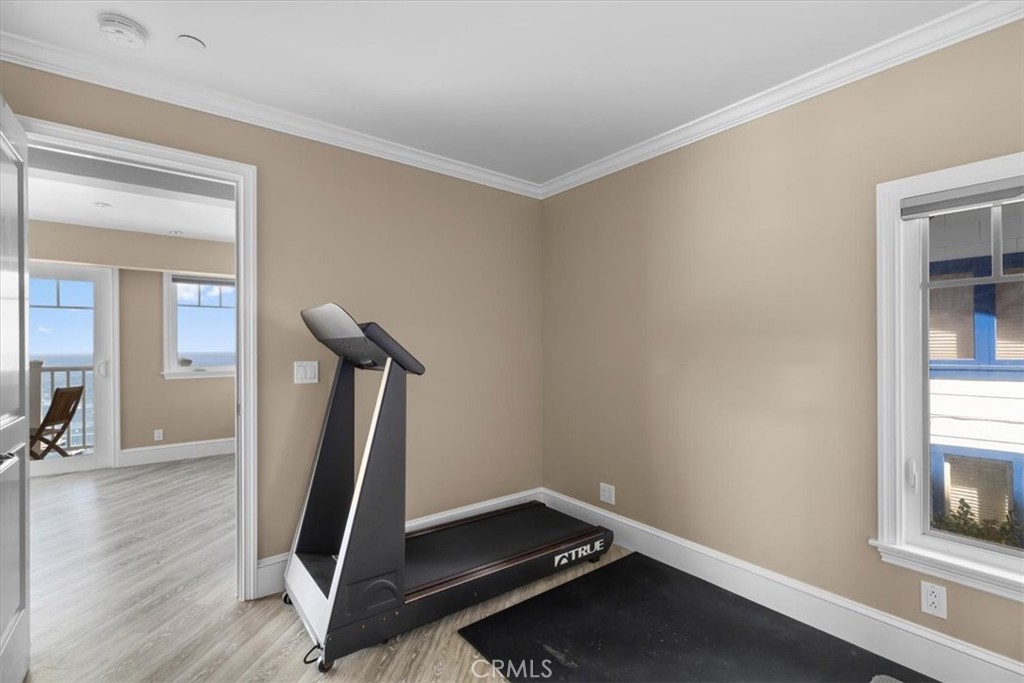 133 Upper Terrace Road Avalon, CA 90704 - Photo 62 of 72 a room with gym equipment and wooden floor
