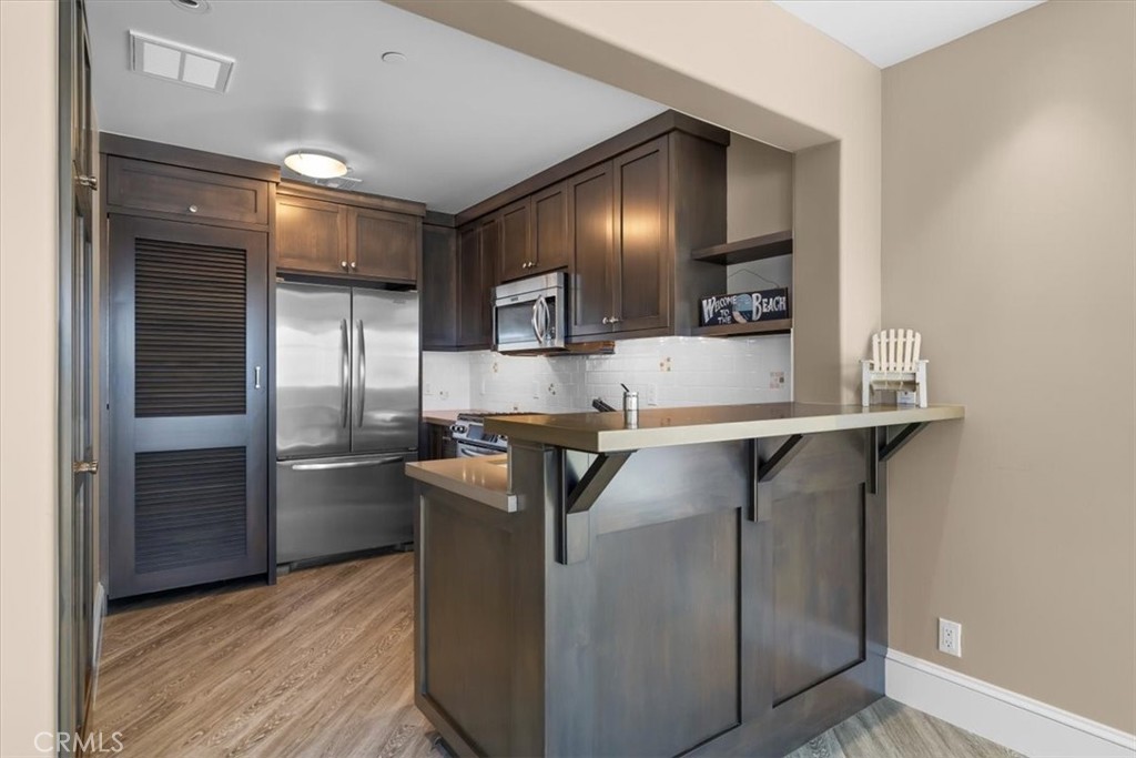 133 Upper Terrace Road Avalon, CA 90704 - Photo 63 of 72 a kitchen with kitchen island a counter top space and stainless steel appliances