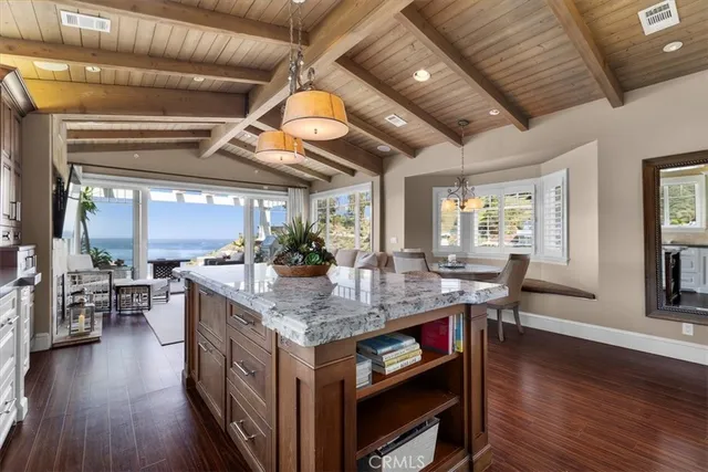 a open kitchen with stainless steel appliances granite countertop a stove and a refrigerator