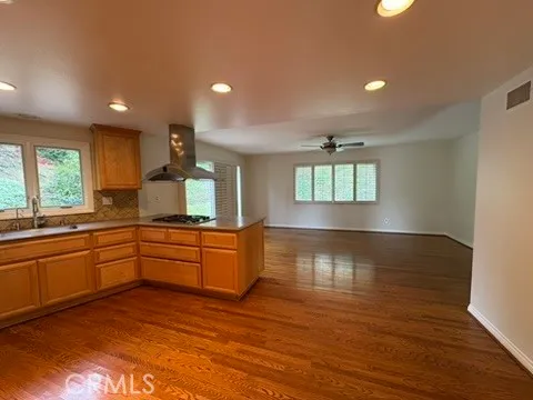 a large kitchen with kitchen island white cabinets and wooden floor