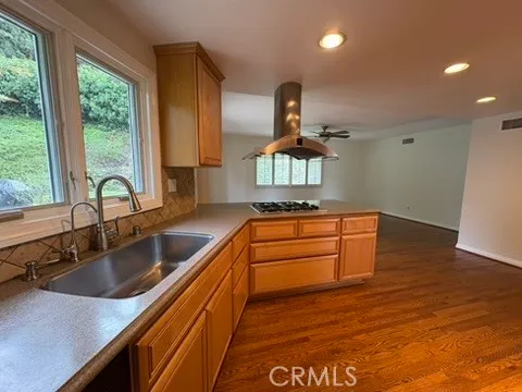 a kitchen with stainless steel appliances granite countertop a sink and a stove