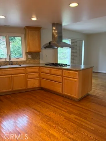 a kitchen with stainless steel appliances granite countertop a stove a sink and a large window