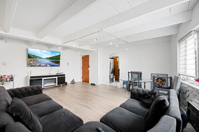 a living room with furniture and kitchen view