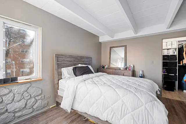 a bedroom with a bed and a window