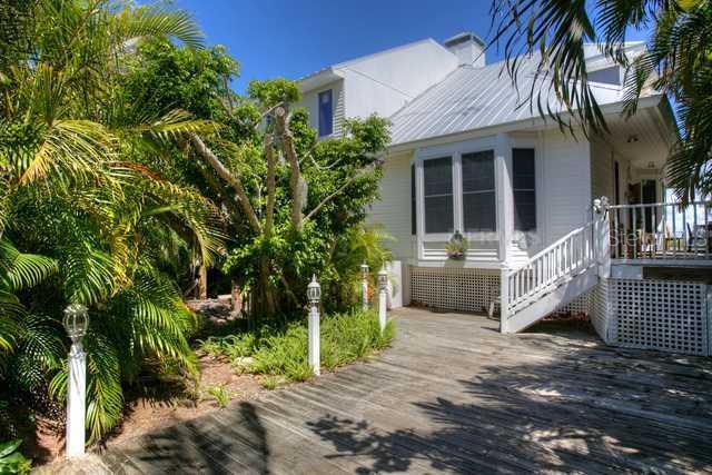 505 Useppa Island Bokeelia, FL 33922 - Photo 1 of 1 a front view of a house with a yard and potted plants