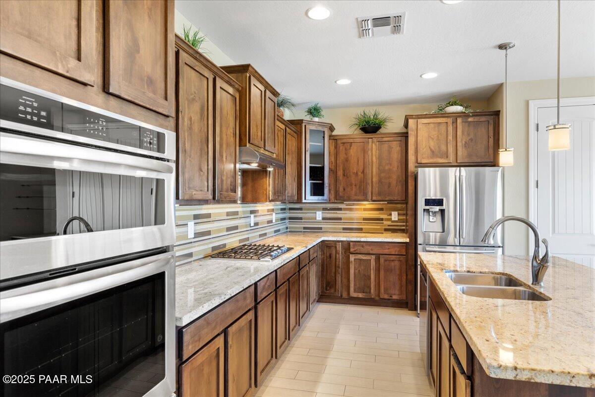 1149 Stack Rock Road Prescott Valley, AZ 86314 - Photo 13 of 85 a kitchen with stainless steel appliances granite countertop a sink stove and cabinets