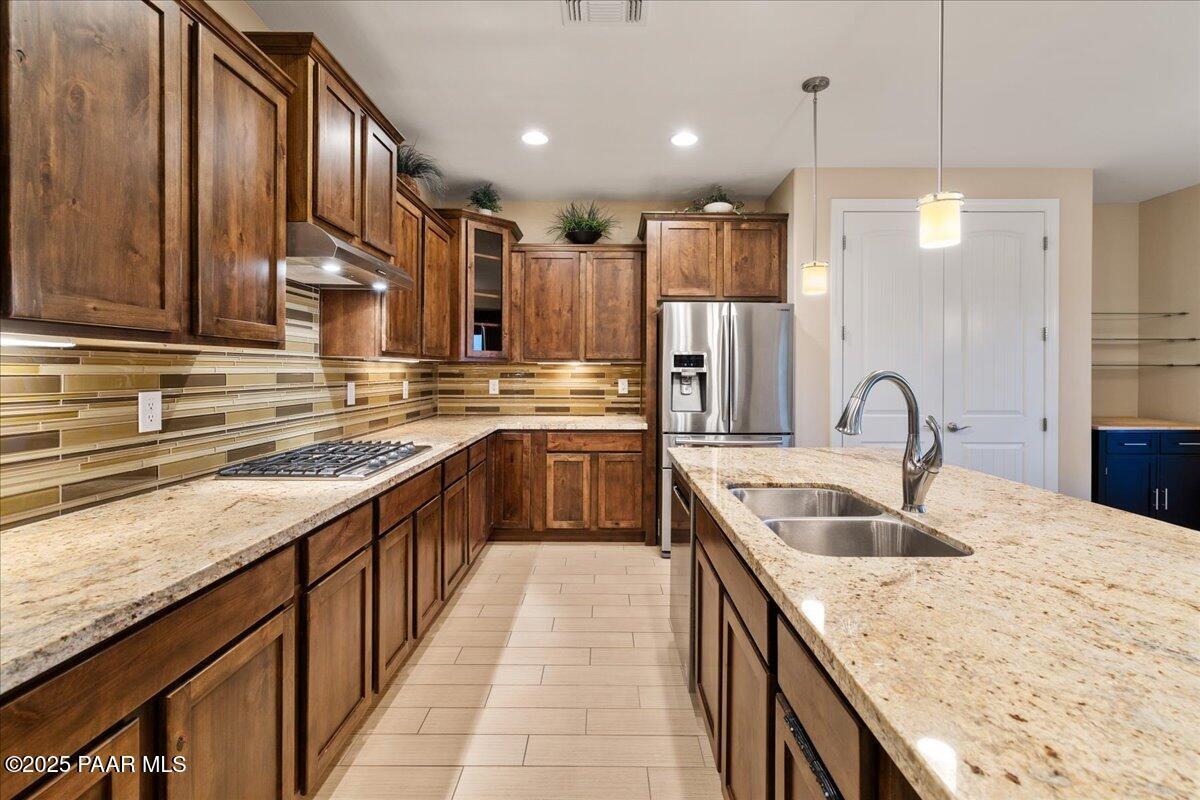1149 Stack Rock Road Prescott Valley, AZ 86314 - Photo 15 of 85 a kitchen with kitchen island granite countertop a sink stainless steel appliances and cabinets