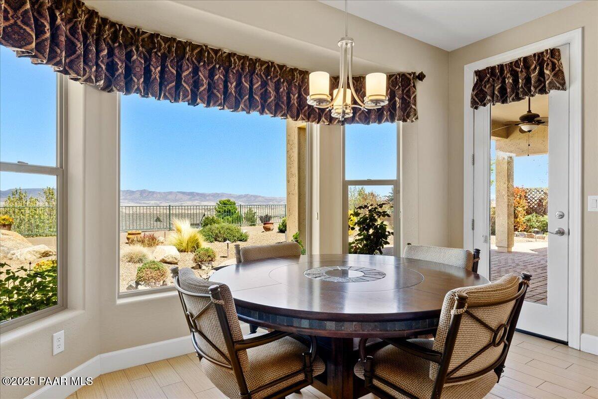 1149 Stack Rock Road Prescott Valley, AZ 86314 - Photo 17 of 85 a view of a dining room with furniture and window