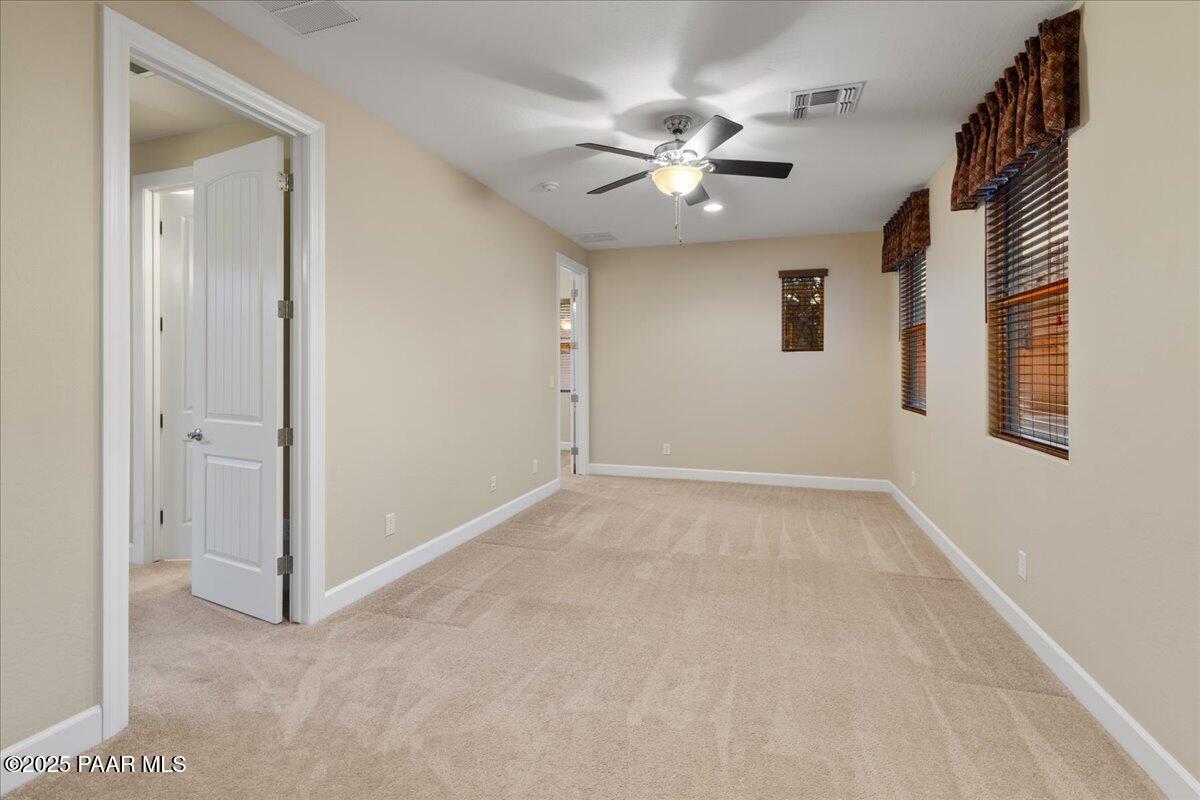 1149 Stack Rock Road Prescott Valley, AZ 86314 - Photo 26 of 85 a view of an empty room with a chandelier fan