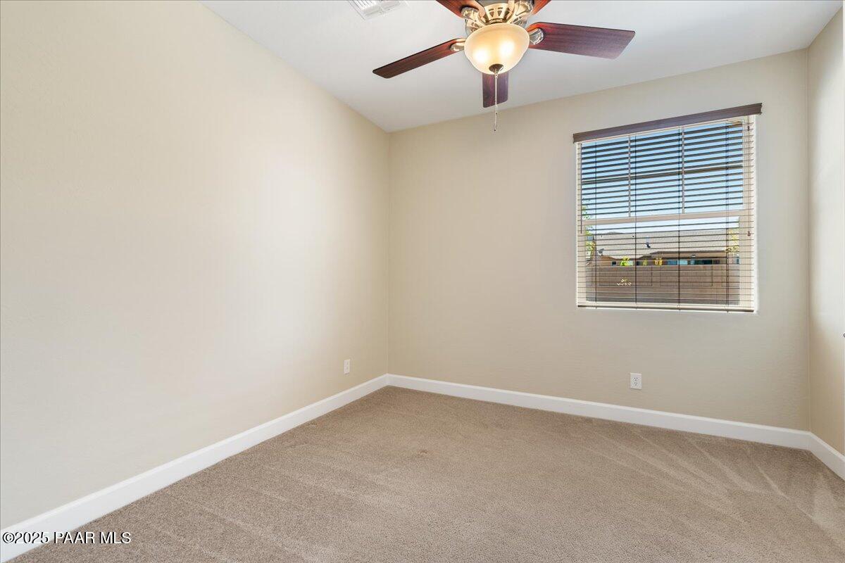 1149 Stack Rock Road Prescott Valley, AZ 86314 - Photo 28 of 85 an empty room with a window and a fan