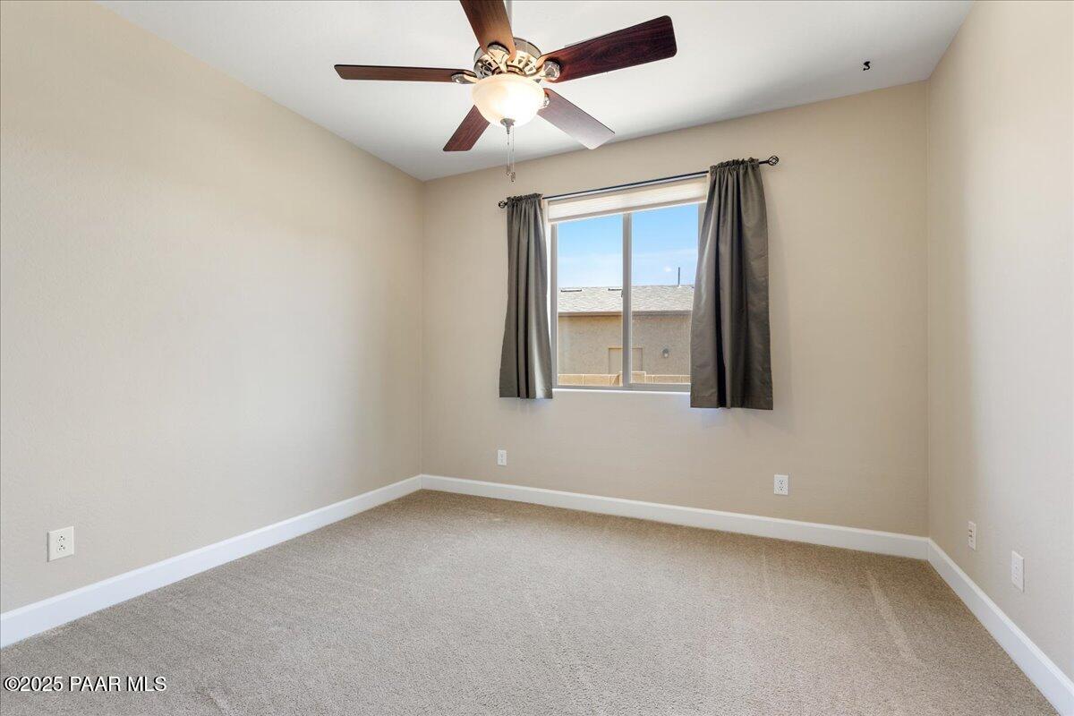 1149 Stack Rock Road Prescott Valley, AZ 86314 - Photo 32 of 85 an empty room with a window and a fan