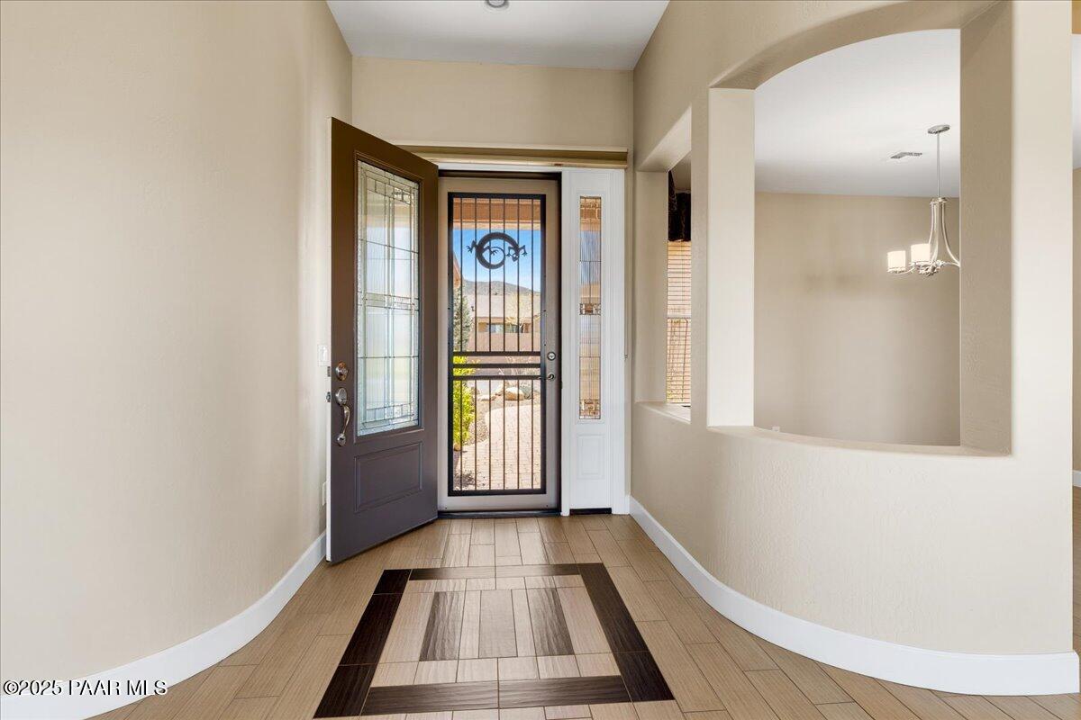 1149 Stack Rock Road Prescott Valley, AZ 86314 - Photo 6 of 85 a view of a hallway with wooden floor and staircase