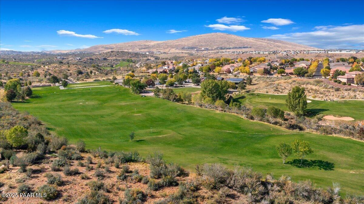 1149 Stack Rock Road Prescott Valley, AZ 86314 - Photo 68 of 85 a view of a grassy field with mountains in the background