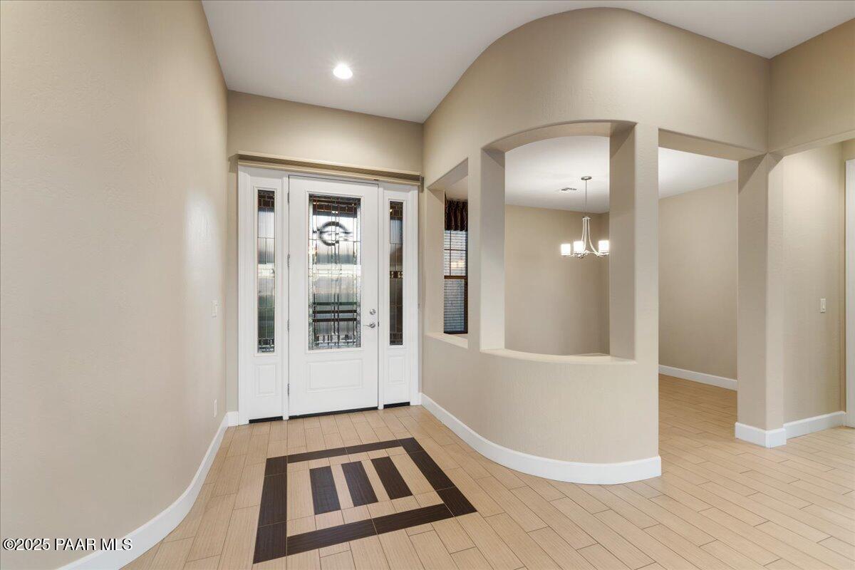 1149 Stack Rock Road Prescott Valley, AZ 86314 - Photo 7 of 85 a view of an empty room with wooden floor and a bathroom