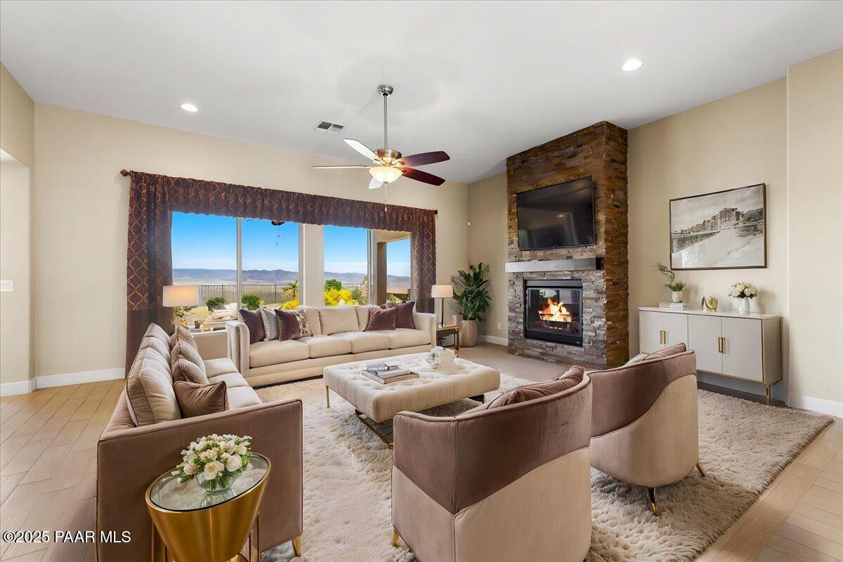 1149 Stack Rock Road Prescott Valley, AZ 86314 - Photo 9 of 85 a living room with furniture a fireplace and a flat screen tv