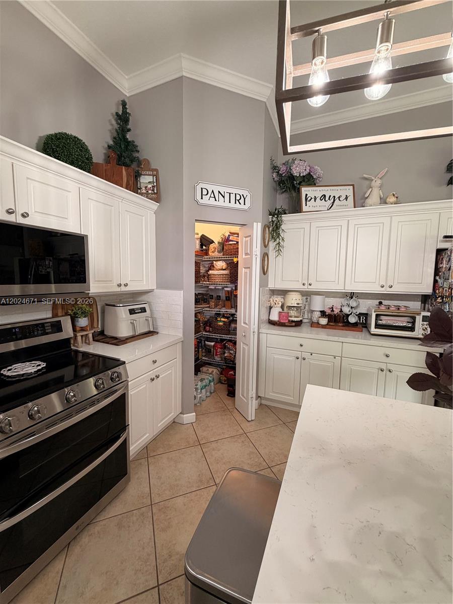 2116 Northeast 38th Road, Unit 2116 Homestead, FL 33033 - Photo 3 of 31 a kitchen with stainless steel appliances and cabinets