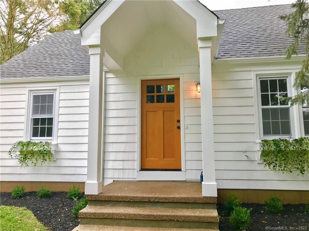 2530 North Benson Road Fairfield, CT 06824 - Photo 1 of 1 a front view of a house with a yard and potted plants