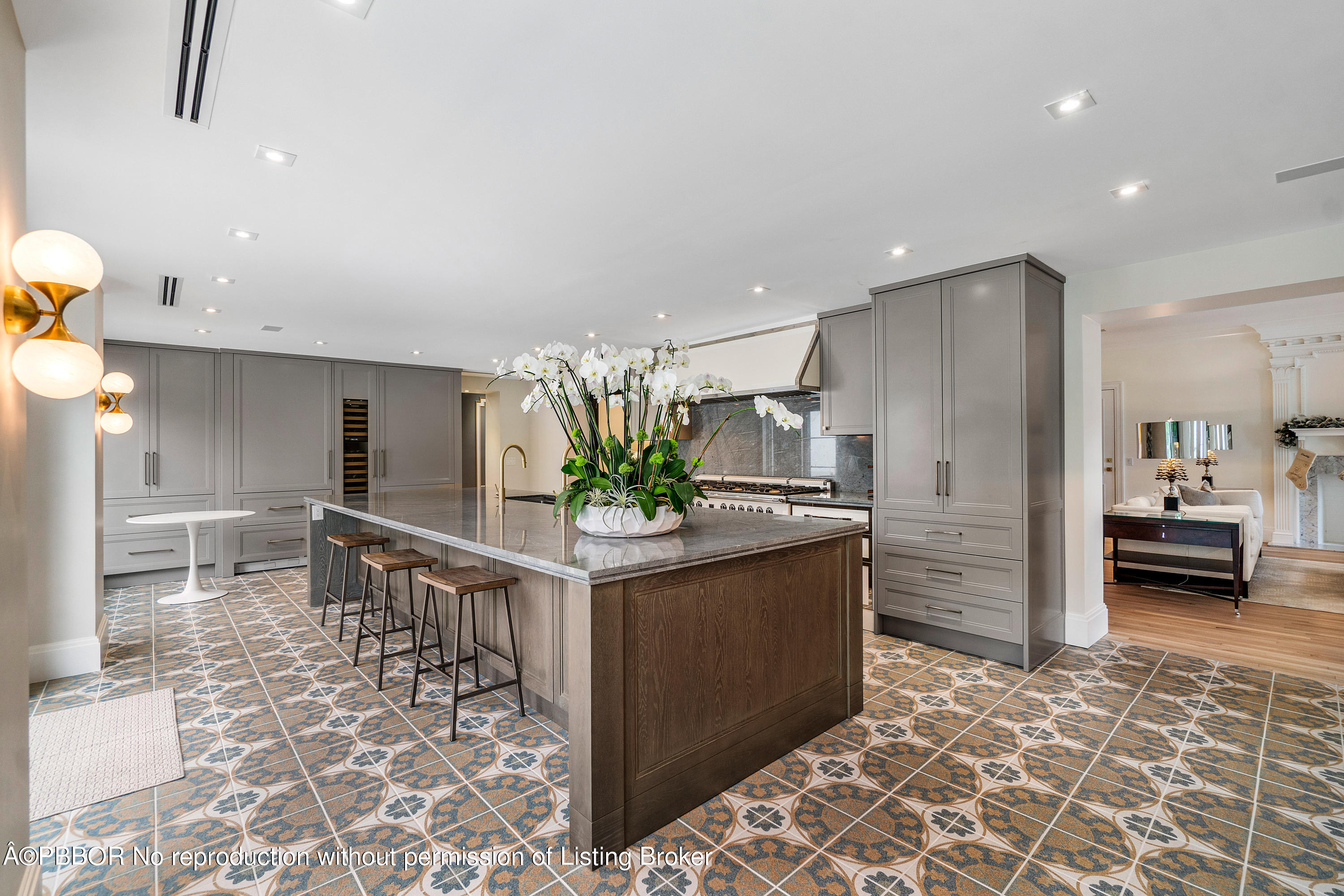 a kitchen with stainless steel appliances kitchen island granite countertop a refrigerator and a sink