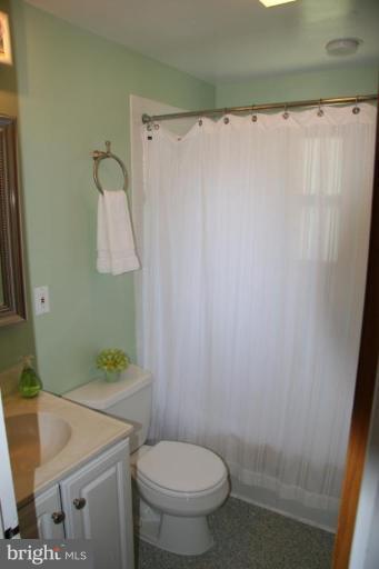 10009 Renfrew Road Silver Spring, MD 20901 - Photo 13 of 13 a white toilet sitting next to a white sink and a shower curtain