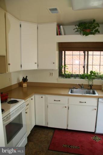 10009 Renfrew Road Silver Spring, MD 20901 - Photo 5 of 13 a kitchen with stainless steel appliances granite countertop a sink a stove and a microwave