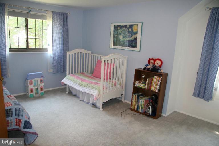 10009 Renfrew Road Silver Spring, MD 20901 - Photo 8 of 13 a room with a bed a baby crib and a chair