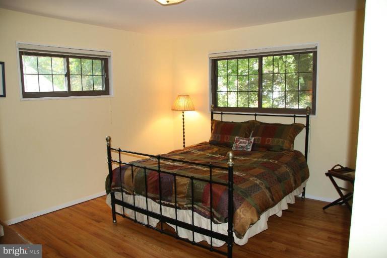 10009 Renfrew Road Silver Spring, MD 20901 - Photo 9 of 13 a bed sitting in a bedroom next to a window