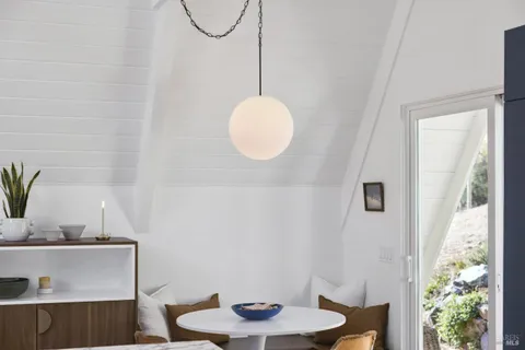 a view of a dining room with furniture and window