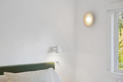 a bedroom with a bed and a window with outer view