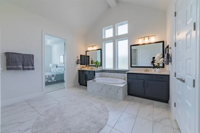 a large bathroom with a large tub and sink