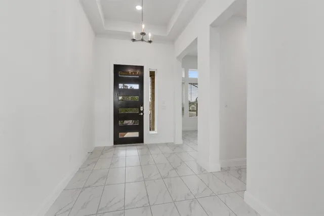 an empty room with closet and windows