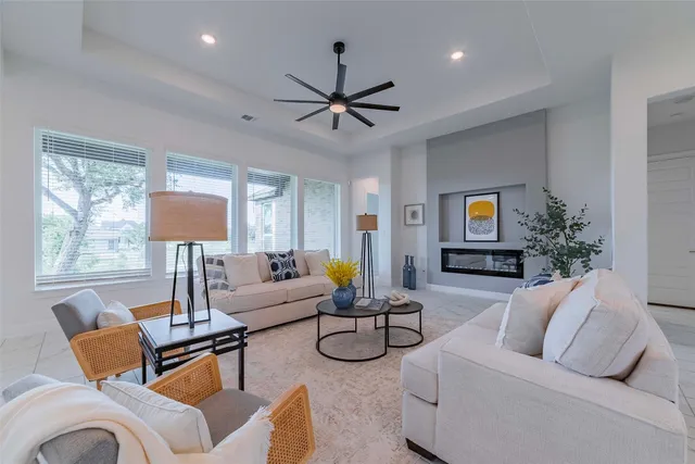 a living room with furniture a chandelier and a couch