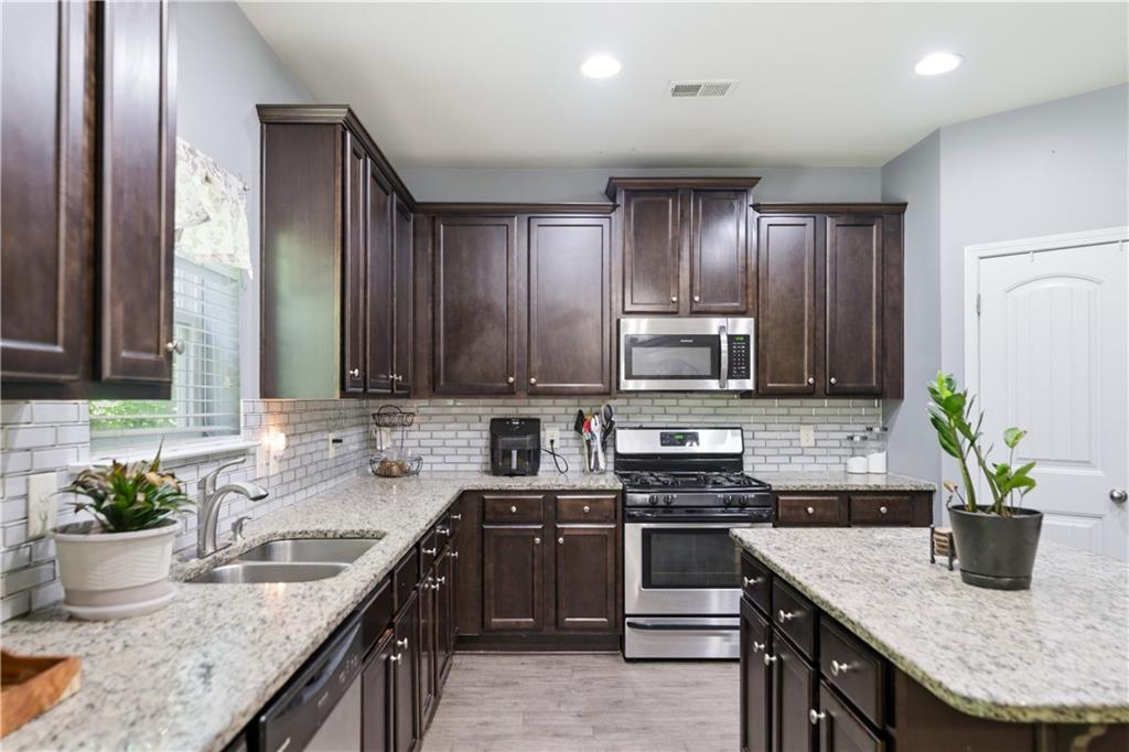 291 Boulder Run Hiram, GA 30141 - Photo 14 of 46 a kitchen with a sink stove and cabinets