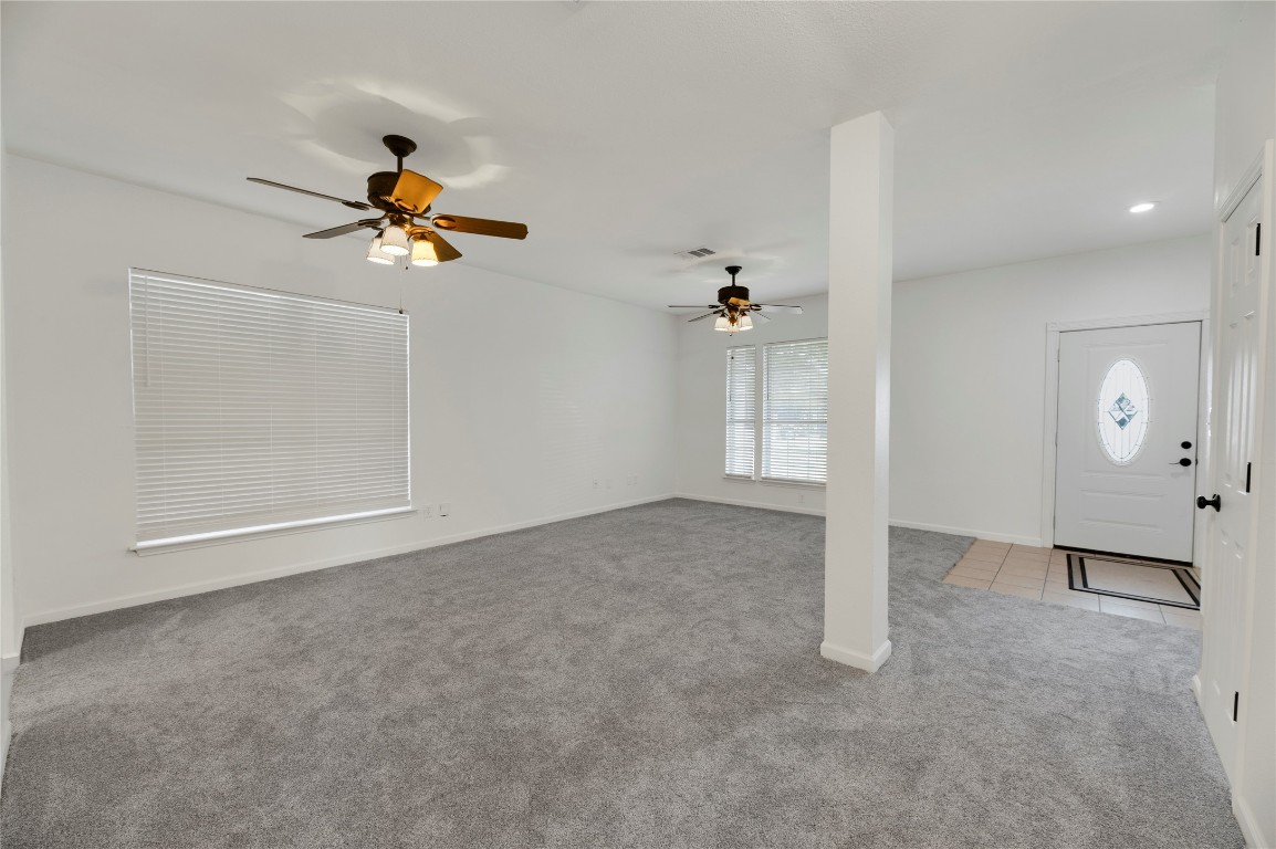 136 Shenandoah Trail Elgin, TX 78621 - Photo 11 of 27 wooden floor in an empty room with a window